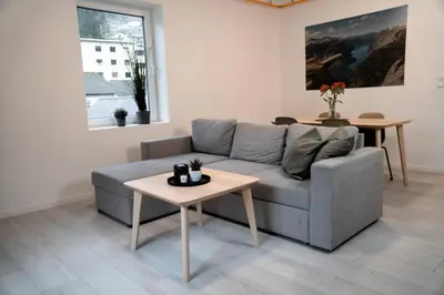 a living room with a couch and a table at Trolltunga Odda Apartments in Odda