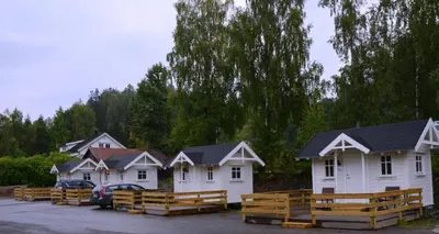 a row of white houses in a parking lot at Lillehammer Camping in Lillehammer