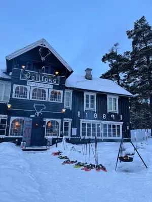 a building with skis in the snow in front of it at Pollfoss Boutique Hotel & Spa in Skjåk