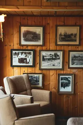 a room with pictures on the wall with two chairs at Pollfoss Boutique Hotel & Spa in Skjåk