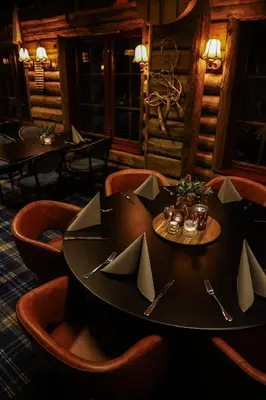 a dining room with a table with paper napkins on it at Pollfoss Boutique Hotel & Spa in Skjåk