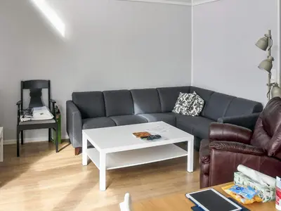 a living room with a couch and a table at 6 person holiday home in Dyrvik in Dyrvik