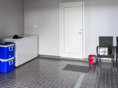 a kitchen with a white door and a tiled floor at 6 person holiday home in Dyrvik in Dyrvik