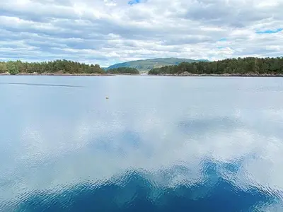 a large body of water with a reflection in the water at 6 person holiday home in LINDÅS in Lindås