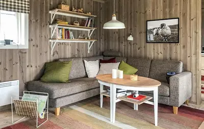 a living room with a couch and a table at Moltebæret in Skåbu