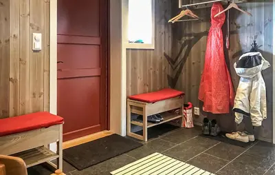 a dressing room with a red dress and a door at Moltebæret in Skåbu