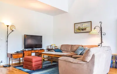 a living room with a couch and a tv at Beautiful Apartment In Årland With Wifi in Hålland