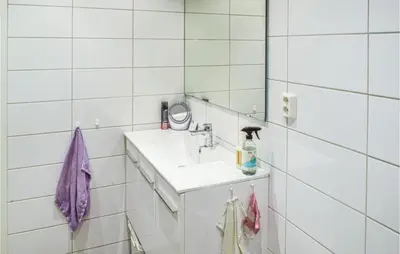 a white bathroom with a sink and a mirror at Beautiful Apartment In Årland With Wifi in Hålland