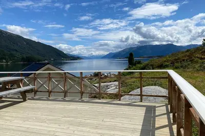 a wooden deck with a view of a lake at Askevika in Vikum