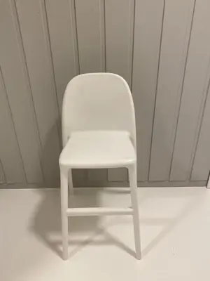 a white chair sitting in a room at Askevika in Vikum