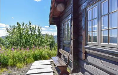 a bench on the side of a building with a window at 3 Bedroom Amazing Home In Uvdal in Uvdal