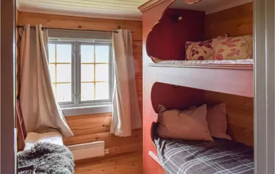 a bedroom with two bunk beds and a window at 3 Bedroom Amazing Home In Uvdal in Uvdal