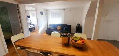 a dining room table with a bowl of fruit on it at Bergen Apartment with Fjord View in Isdalsstø