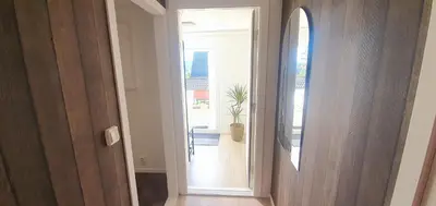 a hallway with a door leading to a room at Bergen Apartment with Fjord View in Isdalsstø