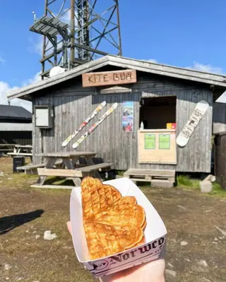 a person holding a box of heart shaped food at Ramsbu utsikt terasse selvhushold in Hovden