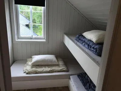 a small room with two beds and a window at Ramsbu utsikt terasse selvhushold in Hovden