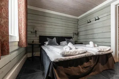 a bed in a room with wooden walls at Storelia in Hemsedal