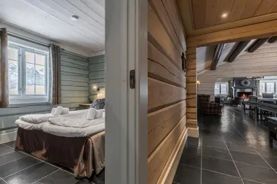 a bedroom with a bed in a room with wooden walls at Storelia in Hemsedal