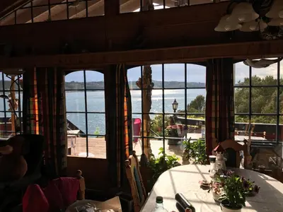 a dining room with a view of the water at Ferienhaus „Draumen“ in Norwegen in Bømlo