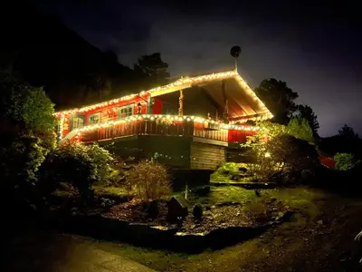 a house with christmas lights on it at night at Ferienhaus „Draumen“ in Norwegen in Bømlo