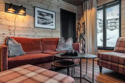 a living room with a couch and a table at Skigaarden in Hemsedal