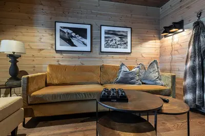 a living room with a couch and a table at Skigaarden in Hemsedal
