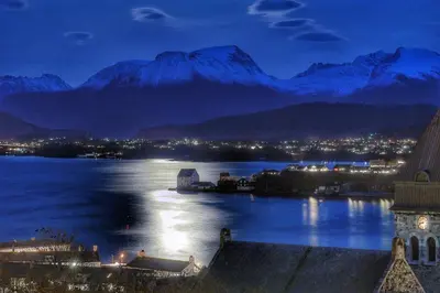 a large body of water with a city and mountains at Bergvegen Guesthouse Aalesund in Ålesund