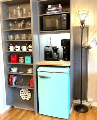 a kitchen with a refrigerator and a microwave at Apartments At The Sentrum in Kristiansund