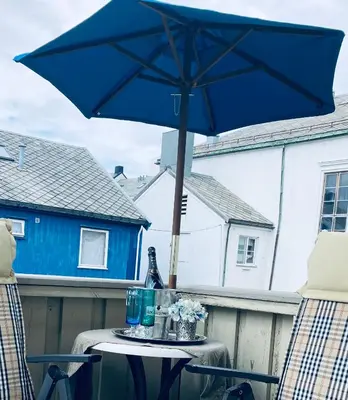 a blue umbrella sitting on top of a table at Apartments At The Sentrum in Kristiansund