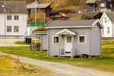 a small house sitting on the side of a dirt road at Ulvik Camping in Ulvik