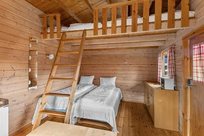 a bedroom with a bunk bed and a ladder at Ulvik Camping in Ulvik