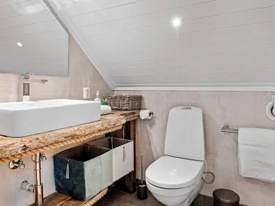 a bathroom with a sink and a toilet at 7 person holiday home in Bud in Bud