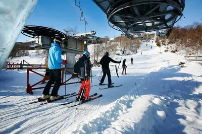 a group of people on a ski lift in the snow at Oppdal Alpintun ski in ski out in Oppdal