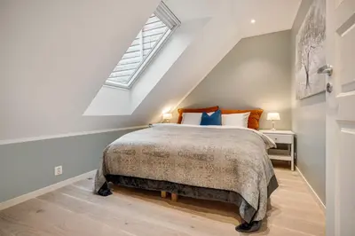 a bedroom with a bed and a window at Keyser Apartments 8 in Bergen