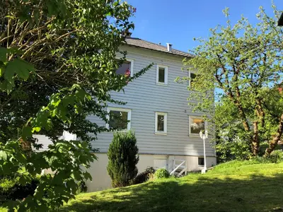 a house on a hill with trees in front of it at # 1 Mountain View with free street parking in Bergen