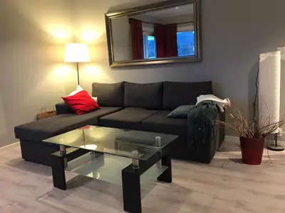a living room with a couch and a glass table at # 1 Mountain View with free street parking in Bergen