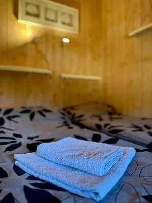 a pair of towels sitting on top of a bed at Modern sports cabin on Sjusjøen with sauna and waxing room in Ringsaker
