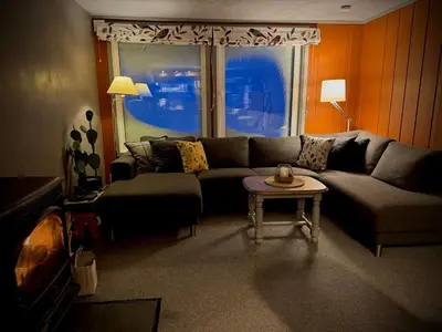 a living room with a couch and a table at Bjørkli Lodge in Geilo