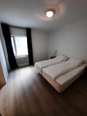 a bedroom with two beds and a large window at Sunndalsøra Hotell in Sunndalsøra