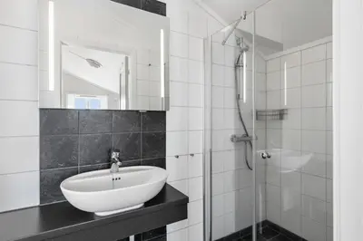 a bathroom with a sink and a shower at Nordpå Fjellhotell AS in Haltdalen