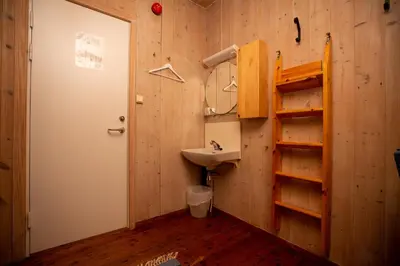 a bathroom with a sink and a mirror at Nordpå Fjellhotell AS in Haltdalen