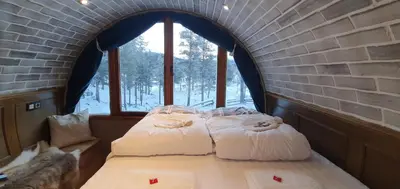a room with two beds in a brick wall at Eventyrhyttene i Jotunheimen in Stuttgongfossen