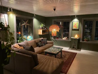a living room with a couch and a table at Nordre Fossheim Gård Hemsedal in Hemsedal