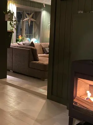 a living room with a couch and a fireplace at Nordre Fossheim Gård Hemsedal in Hemsedal