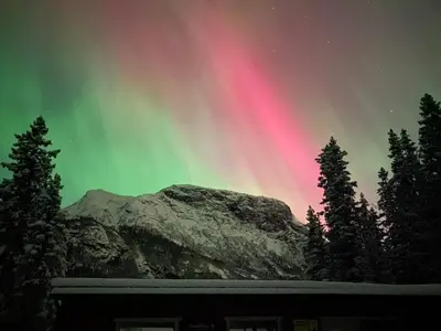 an aurora in the sky over a mountain at Nordre Fossheim Gård Hemsedal in Hemsedal