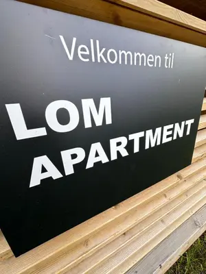 a sign for a loan apartment on a wall at Lom Apartment in Lom