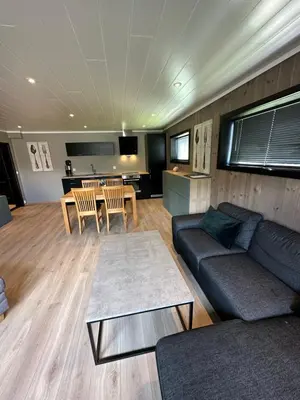 a living room with a couch and a table at Lom Apartment in Lom