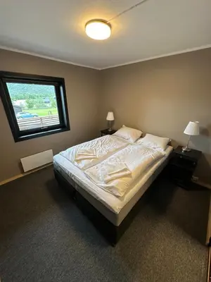 a bedroom with a large bed with a window at Lom Apartment in Lom