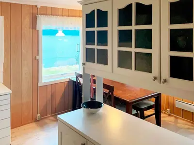 a kitchen with a table and a window at 10 person holiday home in Brekke in Brekke