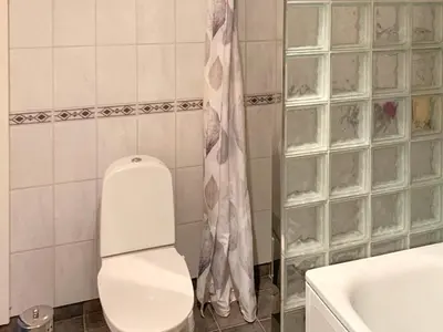 a bathroom with a toilet and a shower and a sink at 10 person holiday home in Brekke in Brekke